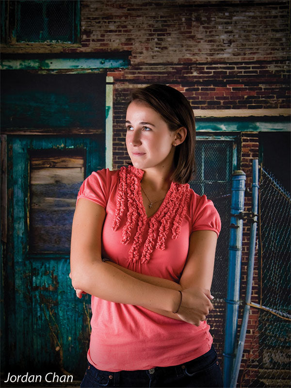 Distressed facade with broken windows, rust stains, and chipped paint.