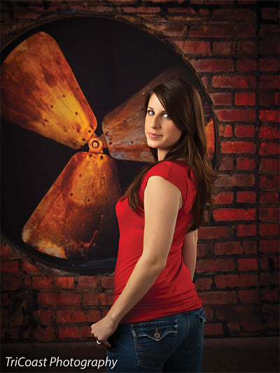 Oversized rusty fan blades built into rough red brick for urban shoots.