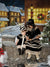 Old-world charm scene with lanterns casting light on snowy cobbles.