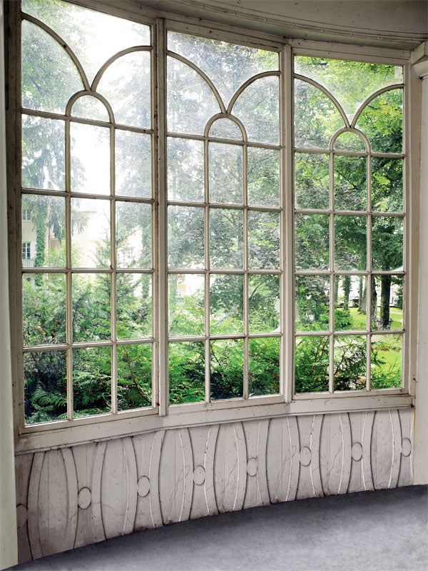 Vintage Curved Window Photography Backdrop - Photography backdrop with a vintage curved window and distressed white wood frame looking out onto a lush green garden.