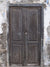Vintage Distressed Wooden Door Photography Backdrop - Rustic distressed wooden door photography backdrop with textured weathered wall, perfect for vintage-themed photoshoots.
