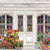 Vintage flower shop photography backdrop featuring an elegant weathered storefront with lush floral arrangements.