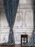 Vintage French Chateau Photography Backdrop - Vintage French interior photography backdrop with blue drapes, a chandelier, and a classic side table.