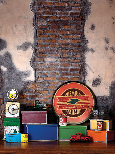 Vintage Garage Toy Display Photography Backdrop - Vintage garage photography backdrop featuring a distressed brick wall, toy trucks, metal garage signs, and colorful boxes. Ideal for retro shoots.