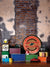 Vintage Garage Toy Display Photography Backdrop - Vintage garage photography backdrop featuring a distressed brick wall, toy trucks, metal garage signs, and colorful boxes. Ideal for retro shoots.