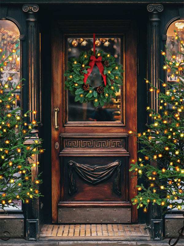 Vintage Holiday Doorway Photography Backdrop - Festive holiday photography backdrop featuring a vintage wooden doorway with a Christmas wreath and twinkling Christmas trees.