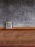 Classic blackboard-style photography backdrop with rustic wooden trim for professional photoshoots and vintage-themed settings.