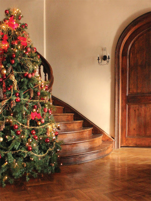Vintage Staircase Christmas Photography Backdrop - Vintage Christmas photography backdrop featuring a decorated tree next to a grand wooden staircase, perfect for holiday photos.