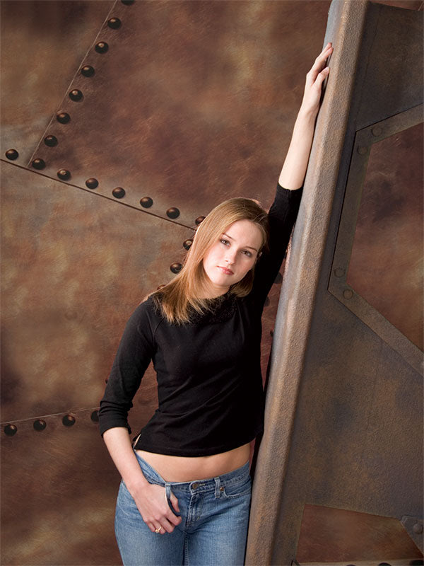 A warm-toned backdrop showcasing weathered steel panels and visible rust patina.