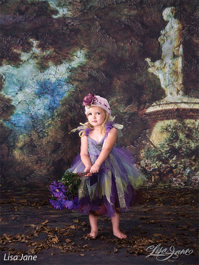Textured backdrop featuring a weathered statue on a pedestal.