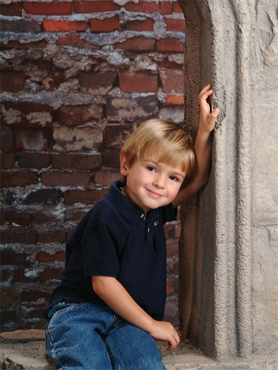A textured brick wall backdrop with aged mortar and earthy tones, perfect for rustic and industrial photography settings.