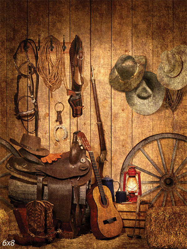 Western Cowboy Photography Backdrop - Western cowboy photography backdrop featuring a barn wall with rustic props like cowboy hats, saddles, and lassos.