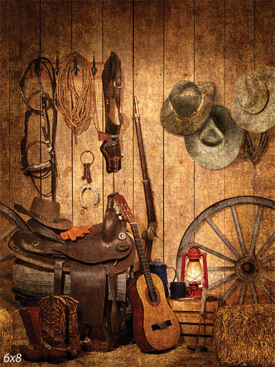 Western Cowboy Photography Backdrop - Western cowboy photography backdrop featuring a barn wall with rustic props like cowboy hats, saddles, and lassos.