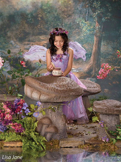 A magical backdrop designed with a hand-painted mystical forest scene and soft glowing elements.