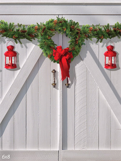 White Christmas Barn Door Photography Backdrop - Photography backdrop featuring a rustic white barn door with a festive wreath and red lanterns for a classic Christmas scene.