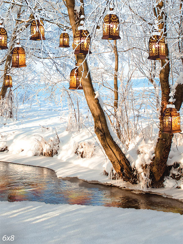 Winter Lantern Forest Photography Backdrop - Photography backdrop of a winter forest scene with lanterns hanging from snow-covered trees.