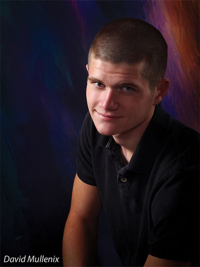 Portrait of a smiling teen boy posed against the Meteoristic backdrop, with bold celestial color blends enhancing the mood.