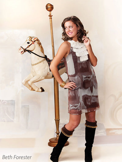 Printed Celestial Garden Backdrop sets a refined scene for a senior model posed with a carousel horse prop.