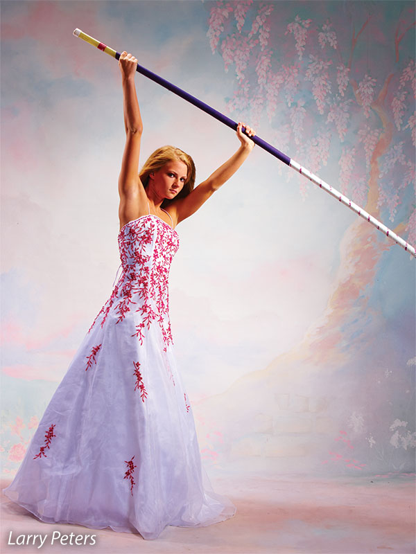 Printed Enchantment Photography Backdrop with cascading wisteria and stone path, shown in use with a senior model posing in formal wear.