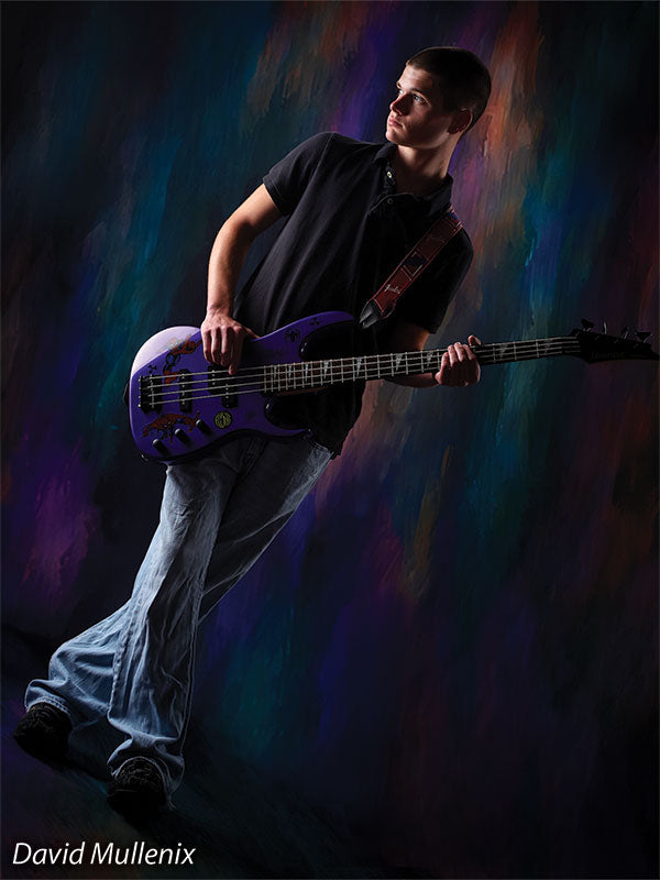 Teen boy poses with electric guitar in front of a cosmic-inspired abstract backdrop with flowing jewel-tone streaks.