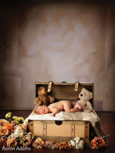 Printed Celestial Garden Backdrop used in a newborn photo scene featuring a sleeping infant surrounded by teddy bears and soft florals.
