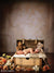 Printed Celestial Garden Backdrop used in a newborn photo scene featuring a sleeping infant surrounded by teddy bears and soft florals.