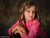 Child model in pink shirt photographed with the Scrolled Backdrop, drawing attention to its antique scroll detail and versatile tone for family portraits.
