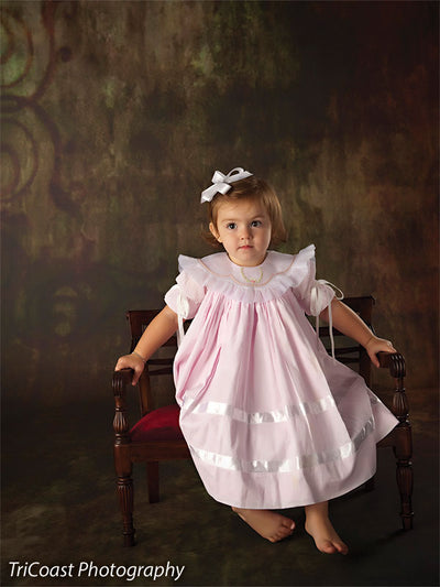 Child model seated on antique furniture against the Scrolled Backdrop, showing its application for fine art and traditional children’s portrait sessions.