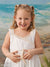Studio photo of young girl with starfish in front of East Coast beach backdrop, ideal for themed family and portrait photography.