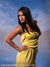 Female model in yellow dress posed against a dramatic painterly Venetian cityscape, perfect for glamour and fashion portraiture.