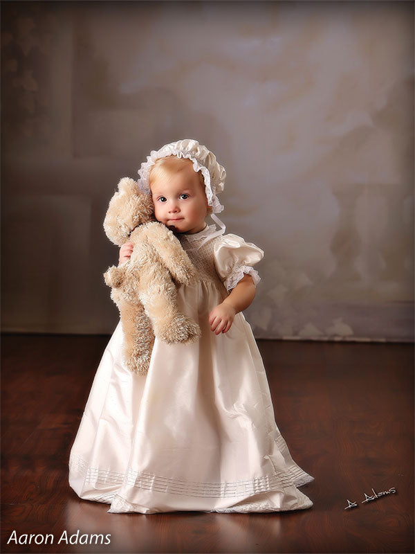 Printed Celestial Garden Backdrop complements a classic toddler portrait with soft, neutral tones and traditional baby attire.