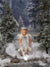 A young girl in fairy wings poses in a winter fantasy setup with the Holiday Cottage backdrop evoking a magical forest tale.